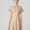 Đầm xoè tay cape đính cúc